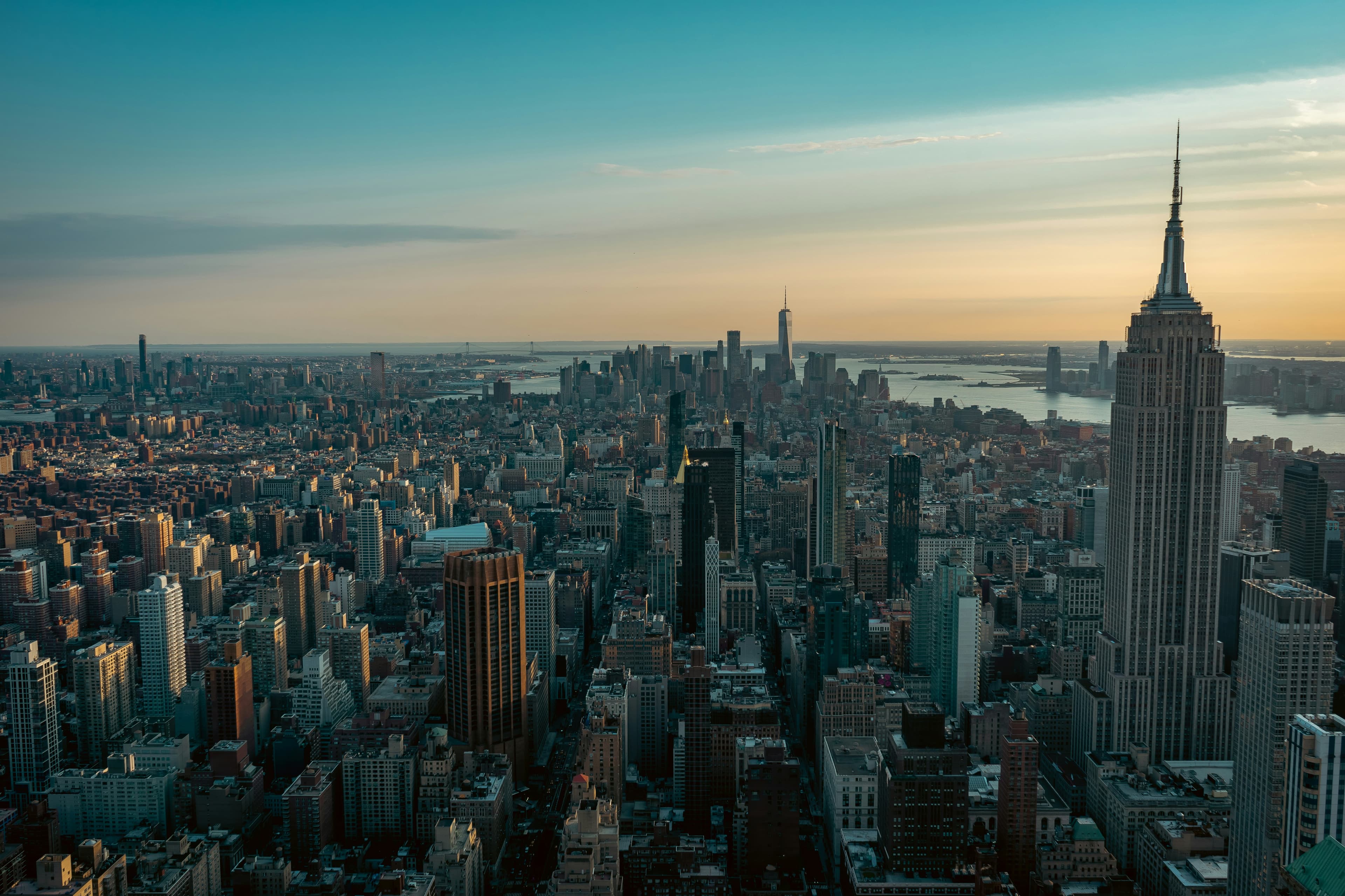 Midtown and lower Manhattan at dusk, seen from above, the harbour beyond
